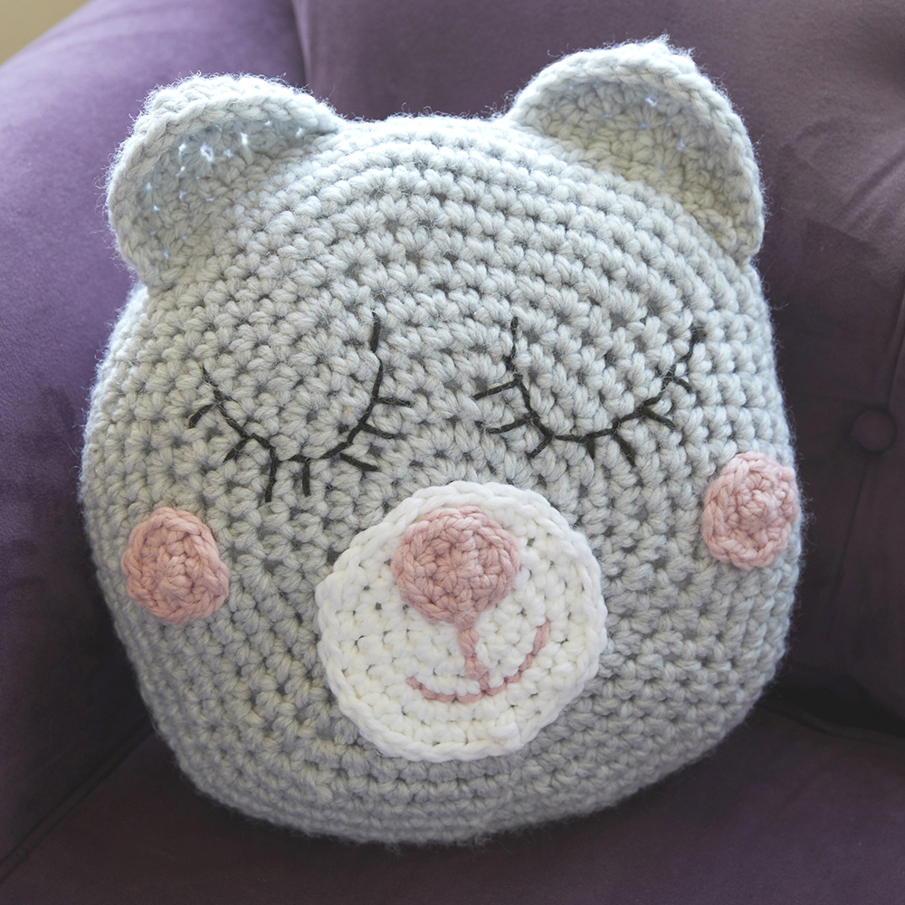 This Sleepy Teddy Pillow is the perfect crossover between a pillow and a stuffed animal. #crochetpillow #crochetcushion #crochetpattern #crochetlove #crochetaddict