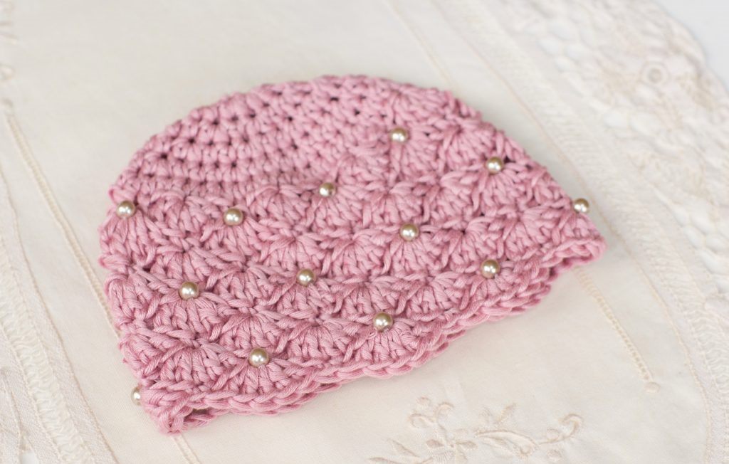 Vintage Pearl Hat - These free newborn crochet hat patterns are fun and easy to work on. These baby accessories are so fast to make and anyone can do it. #CrochetBabyHatPatterns #CrochetHatPatterns #CrochetNewbornHats