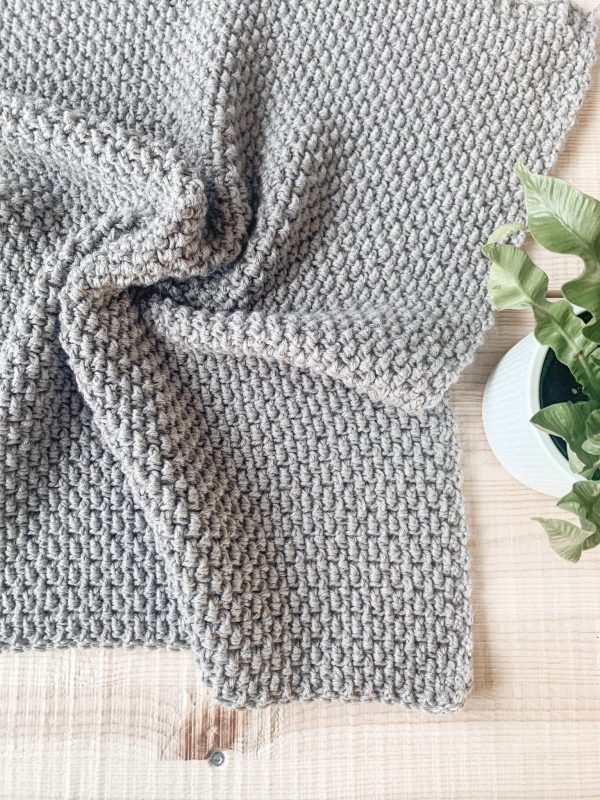crumpled grey crochet seedling blanket
