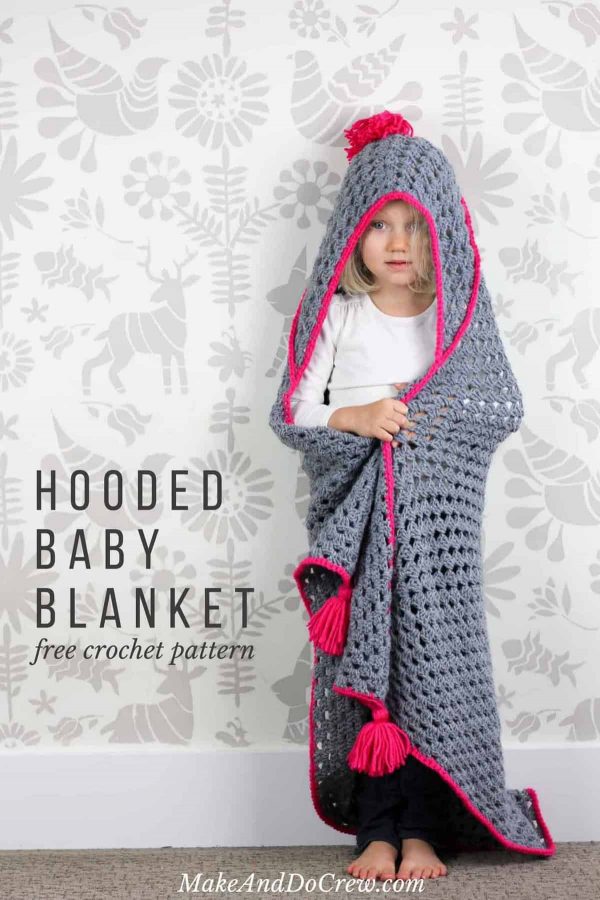 A girl wrapped with the Crochet Hooded Baby Blanket